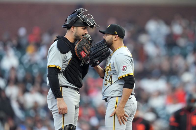 Apr 27, 2024; San Francisco, California, USA; Pittsburgh Pirates catcher Joey Bart (left) and starting pitcher Martin Perez (54) talk during the fourth inning against the San Francisco Giants at Oracle Park. Mandatory Credit: Darren Yamashita-USA TODAY Sports