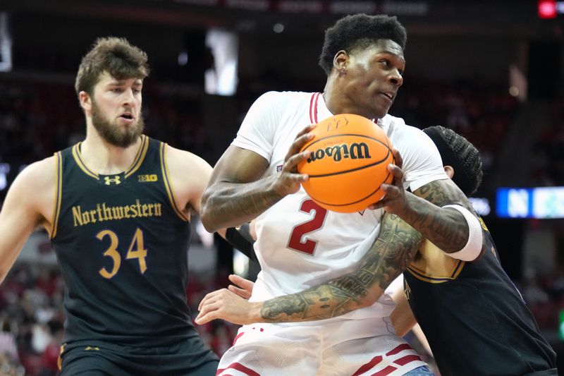 Jan 13, 2024; Madison, Wisconsin, USA; Wisconsin Badgers guard AJ Storr (2) looks to the basket against Northwestern Wildcats guard Boo Buie (0) and center Matthew Nicholson (34) during the second half at the Kohl Center. Mandatory Credit: Kayla Wolf-USA TODAY Sports