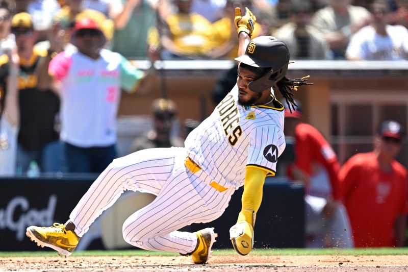 Jun 26, 2024; San Diego, California, USA; San Diego Padres third baseman Eguy Rosario (5) slides home to score a run on a wild pitch during the fourth inning against the Washington Nationals at Petco Park. Mandatory Credit: Orlando Ramirez-USA TODAY Sports