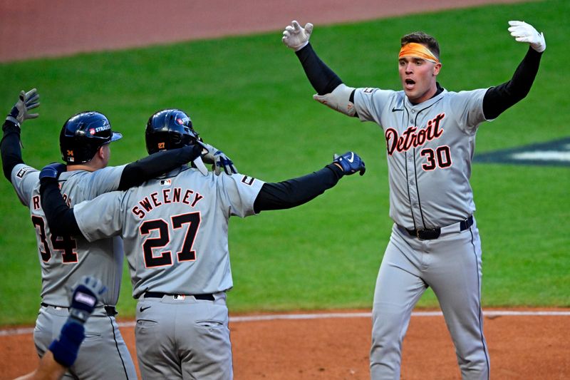 Oct 7, 2024; Cleveland, Ohio, USA; Detroit Tigers outfielder Kerry Carpenter (30) celebrates with catcher Jake Rogers (34) and shortstop Trey Sweeney (27) after hitting a three run home run during the ninth inning against the Cleveland Guardians during game two of the ALDS for the 2024 MLB Playoffs at Progressive Field. Mandatory Credit: David Richard-Imagn Images