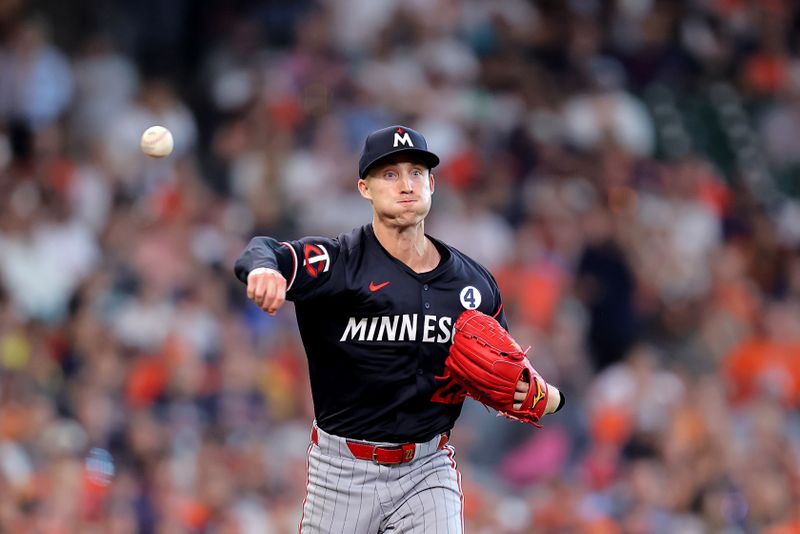 Jun 2, 2024; Houston, Texas, USA; Minnesota Twins relief pitcher Griffin Jax (23) throws a fielded ball to first for an out against the Houston Astros during the eighth inning at Minute Maid Park. Mandatory Credit: Erik Williams-USA TODAY Sports