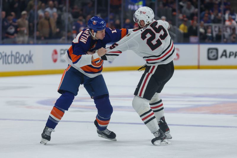 Apr 2, 2024; Elmont, New York, USA; New York Islanders left wing Matt Martin (17) and Chicago Blackhawks defenseman Jarred Tinordi (25) fight during the first period at UBS Arena. Mandatory Credit: Thomas Salus-USA TODAY Sports