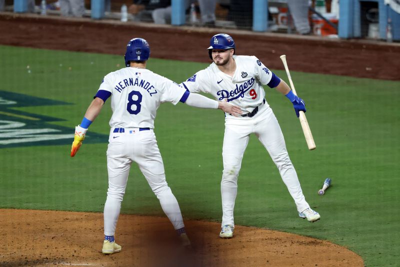 Oct 25, 2024; Los Angeles, California, USA; Los Angeles Dodgers outfielder Enrique Hernandez (8) celebrates with second baseman Gavin Lux (9) after scoring in the fifth inning against the New York Yankees during game one of the 2024 MLB World Series at Dodger Stadium. Mandatory Credit: Kiyoshi Mio-Imagn Images