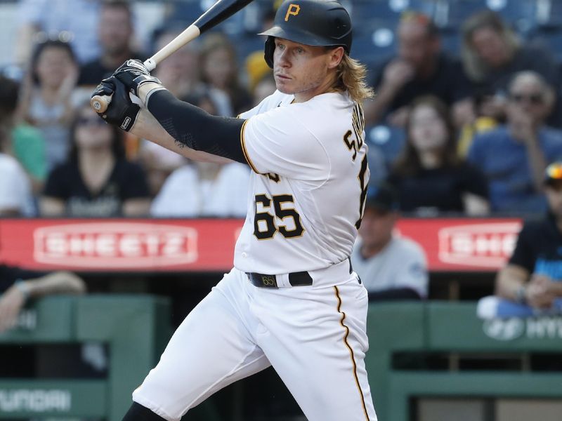 Oct 1, 2023; Pittsburgh, Pennsylvania, USA;  Pittsburgh Pirates left fielder Jack Suwinski (65) hits a two-run single against the Miami Marlins during the eighth inning at PNC Park. Pittsburgh won 3-0. Mandatory Credit: Charles LeClaire-USA TODAY Sports