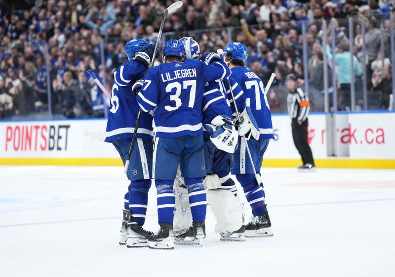 Mar 6, 2024; Toronto, Ontario, CAN; Toronto Maple Leafs defenseman Timothy Liljegren (37) celebrates the win with Toronto Maple Leafs goaltender Ilya Samsonov (35) against the Buffalo Sabres at the end of the overtime period at Scotiabank Arena. Mandatory Credit: Nick Turchiaro-USA TODAY Sports