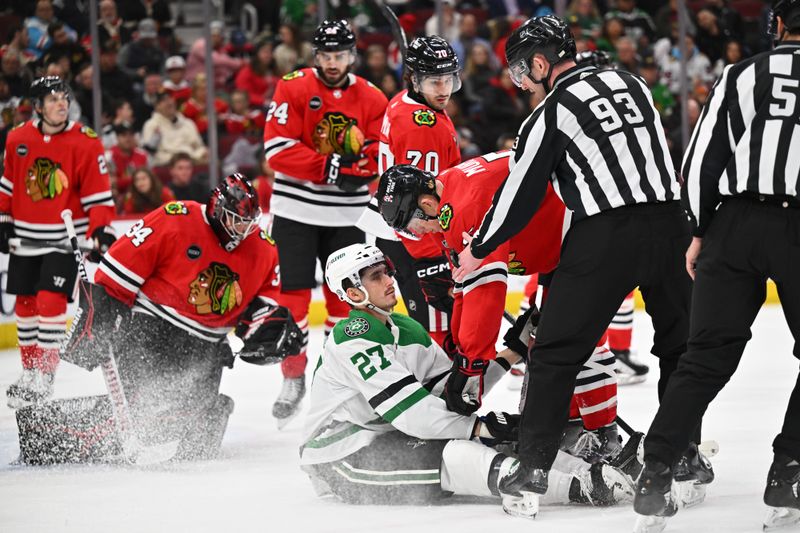 Jan 13, 2024; Chicago, Illinois, USA;  Chicago Blackhawks defenseman Connor Murphy (5) holds down Dallas Stars forward Mason Marchement (27) after the whistle in front of the Chicago net in the second period at United Center. Mandatory Credit: Jamie Sabau-USA TODAY Sports