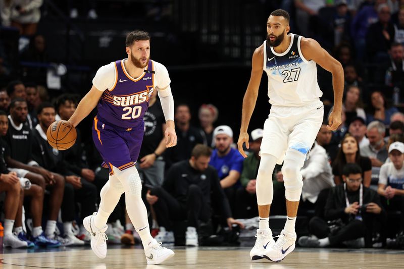 MINNEAPOLIS, MINNESOTA - NOVEMBER 17: Jusuf Nurkic #20 of the Phoenix Suns dribbles the ball against Rudy Gobert #27 of the Minnesota Timberwolves in the first quarter of the game at Target Center on November 17, 2024 in Minneapolis, Minnesota. NOTE TO USER: User expressly acknowledges and agrees that, by downloading and or using this photograph, User is consenting to the terms and conditions of the Getty Images License Agreement. (Photo by David Berding/Getty Images)