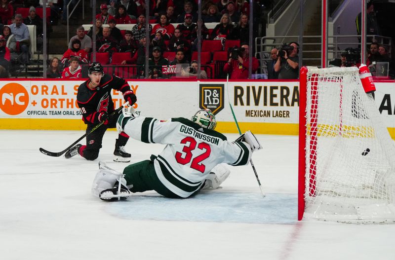 Jan 21, 2024; Raleigh, North Carolina, USA; Carolina Hurricanes center Martin Necas (88) scores a goal past Minnesota Wild goaltender Filip Gustavsson (32) during the first period at PNC Arena. Mandatory Credit: James Guillory-USA TODAY Sports