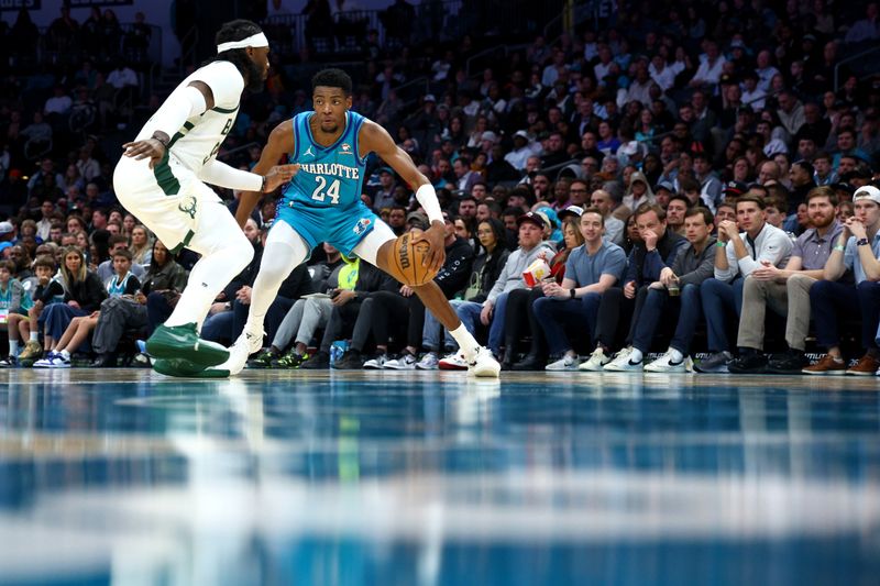 CHARLOTTE, NORTH CAROLINA - FEBRUARY 29: Brandon Miller #24 of the Charlotte Hornets dribbles against Jae Crowder #99 of the Milwaukee Bucks during the first half of the game at Spectrum Center on February 29, 2024 in Charlotte, North Carolina. NOTE TO USER: User expressly acknowledges and agrees that, by downloading and or using this photograph, User is consenting to the terms and conditions of the Getty Images License Agreement. (Photo by Jared C. Tilton/Getty Images)