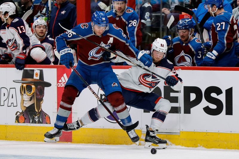 Mar 22, 2024; Denver, Colorado, USA; Colorado Avalanche right wing Mikko Rantanen (96) and Columbus Blue Jackets left wing Alexander Nylander (92) battle for the puck in the first period at Ball Arena. Mandatory Credit: Isaiah J. Downing-USA TODAY Sports