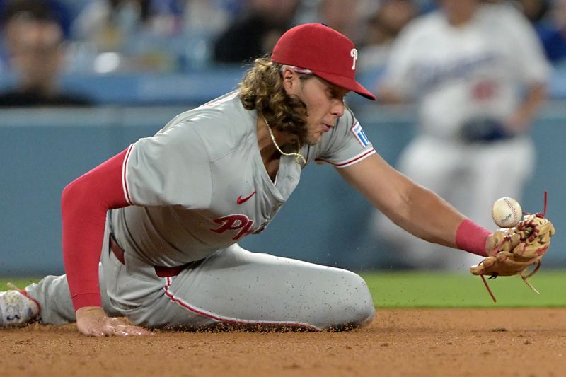 Aug 5, 2024; Los Angeles, California, USA;  Philadelphia Phillies third baseman Alec Bohm (28) makes a play off a ground ball hit by Los Angeles Dodgers shortstop Nick Ahmed (12) and throws him out at first base in the eighth inning at Dodger Stadium. Mandatory Credit: Jayne Kamin-Oncea-USA TODAY Sports