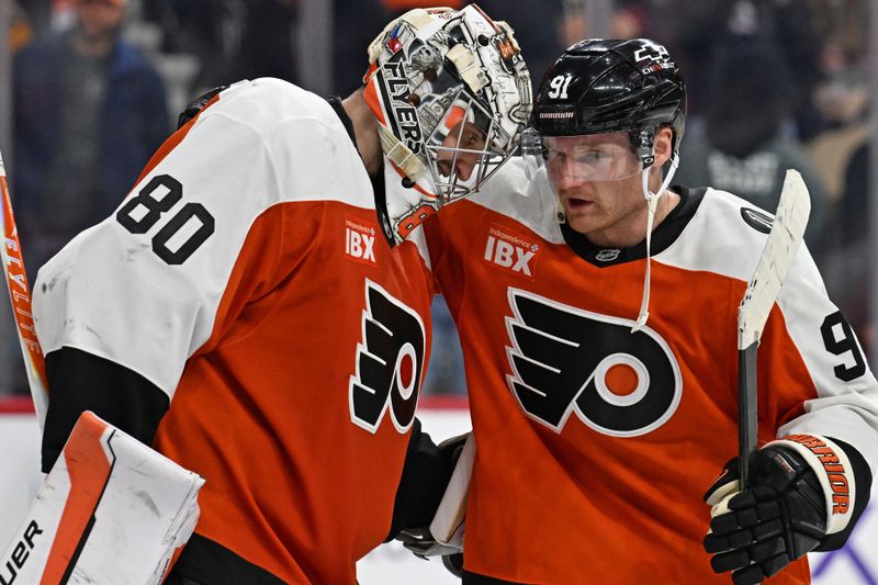 Dec 22, 2025; Philadelphia, Pennsylvania, USA; Philadelphia Flyers goaltender Dan Vladar (80) and right wing Carl Grundstrom (91) celebrate win against the Vancouver Canucks at Xfinity Mobile Arena. Mandatory Credit: Eric Hartline-Imagn Images