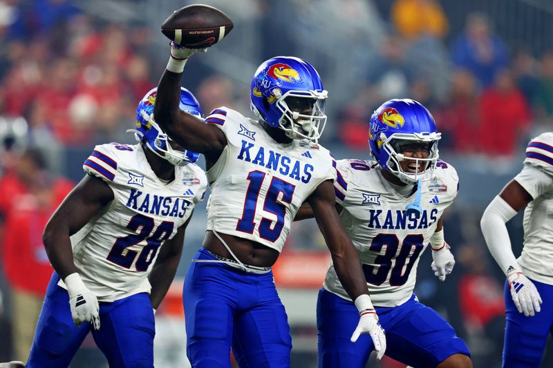 Dec 26, 2023; Phoenix, AZ, USA; Kansas Jayhawks linebacker Craig Young (15) celebrates with his teammates after making an interception during the second half against the UNLV Rebels in the Guaranteed Rate Bowl at Chase Field. Mandatory Credit: Mark J. Rebilas-USA TODAY Sports