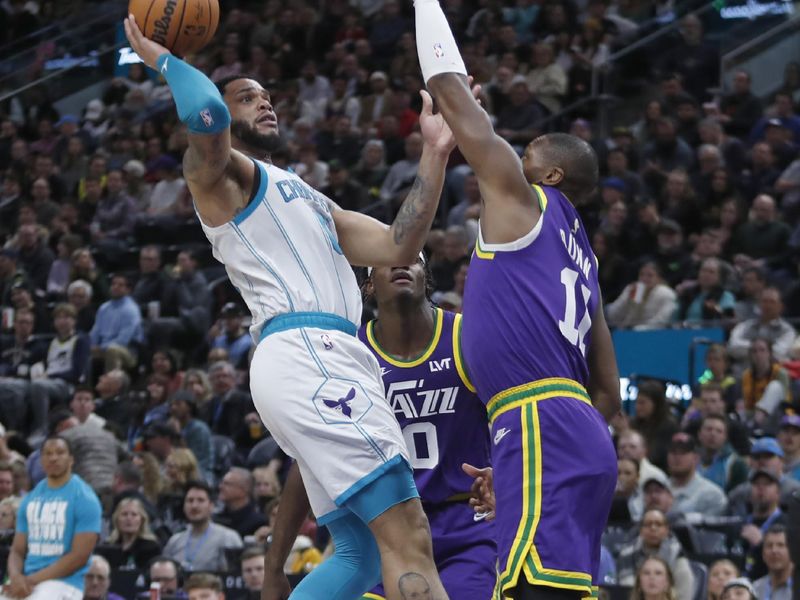 SALT LAKE CITY, UT - FEBRUARY 22:  Miles Bridges #0  of the Charlotte Hornets shoots over Kris Dunn #11 of the Utah Jazz during the second half of their game at the Delta Center on February 22, 2024 in Salt Lake City, Utah.  NOTE TO USER: User expressly acknowledges and agrees that, by downloading and or using this Photograph, User is concenting to the terms and conditions of the Getty Images license Agreement. (Photo by Chris Gardner/Getty Images)