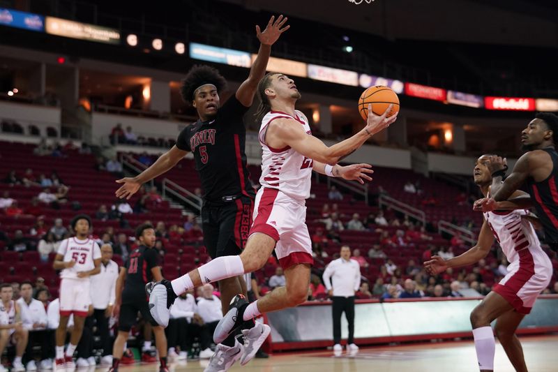 Feb 14, 2024; Fresno, California, USA; Fresno State Bulldogs guard Isaiah Pope (21) misses a shot under the hoop in front of UNLV Rebels forward Rob Whaley Jr. (5) in the second half at the Save Mart Center. Mandatory Credit: Cary Edmondson-USA TODAY Sports