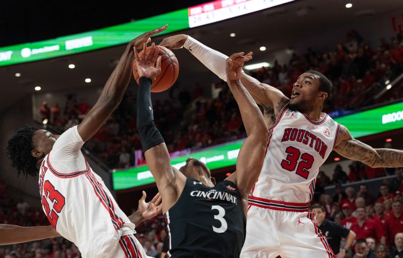 Jan 28, 2023; Houston, Texas, USA; Cincinnati Bearcats guard Mika Adams-Woods (3) shot is blocked by Houston Cougars guard Terrance Arceneaux (23) and forward Reggie Chaney (32) in the second half at Fertitta Center. Houston Cougars won 75-69 .Mandatory Credit: Thomas Shea-USA TODAY Sports