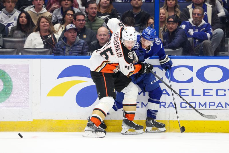 Jan 13, 2024; Tampa, Florida, USA;  Anaheim Ducks defenseman Ilya Lyubushkin (46) and Tampa Bay Lightning center Brayden Point (21) battle for the puck in the first period  at Amalie Arena. Mandatory Credit: Nathan Ray Seebeck-USA TODAY Sports