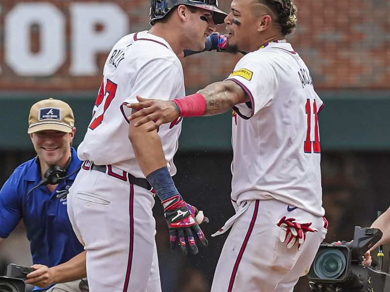 Apr 26, 2024; Cumberland, Georgia, USA; Atlanta Braves third baseman Austin Riley (27) reacts with shortstop Orlando Arcia (11) after hitting the game winning single against the Cleveland Guardians during the tenth inning at Truist Park. Mandatory Credit: Dale Zanine-USA TODAY Sports