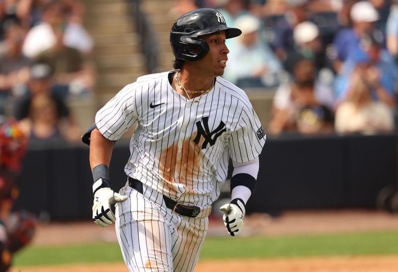 Mar 10, 2024; Tampa, Florida, USA; New York Yankees infielder Oswaldo Cabrera (95) hits a single against the Atlanta Braves during the fifth inning at George M. Steinbrenner Field. Mandatory Credit: Kim Klement Neitzel-USA TODAY Sports