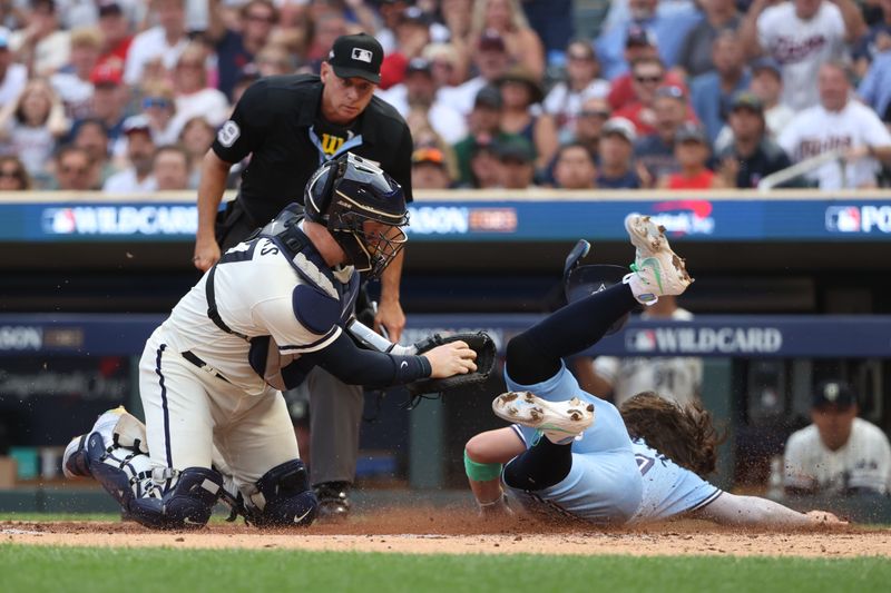 Oct 3, 2023; Minneapolis, Minnesota, USA; Minnesota Twins catcher Ryan Jeffers (27) tags out Toronto Blue Jays shortstop Bo Bichette (11) in the fourth inning during game one of the Wildcard series for the 2023 MLB playoffs at Target Field. Mandatory Credit: Jesse Johnson-USA TODAY Sports