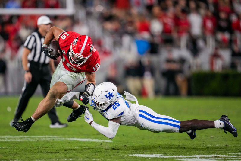 Oct 7, 2023; Athens, Georgia, USA; Georgia Bulldogs tight end Brock Bowers (19) breaks a tackle by Kentucky Wildcats defensive back Jordan Lovett (25) during the second half at Sanford Stadium. Mandatory Credit: Dale Zanine-USA TODAY Sports