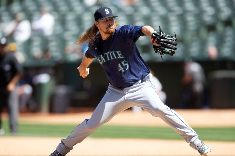 Jun 6, 2024; Oakland, California, USA; Seattle Mariners pitcher Ryne Stanek (45) delivers a pitch against the Oakland Athletics during the ninth inning at Oakland-Alameda County Coliseum. Mandatory Credit: D. Ross Cameron-USA TODAY Sports