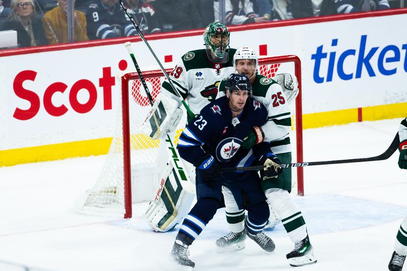 Feb 20, 2024; Winnipeg, Manitoba, CAN; Winnipeg Jets forward Sean Monahan (23) jostles for position with Minnesota Wild defenseman Jonas Brodin (25) in front of Minnesota Wild goalie Marc-Andre Fleury (29) during third period at Canada Life Centre. Mandatory Credit: Terrence Lee-USA TODAY Sports