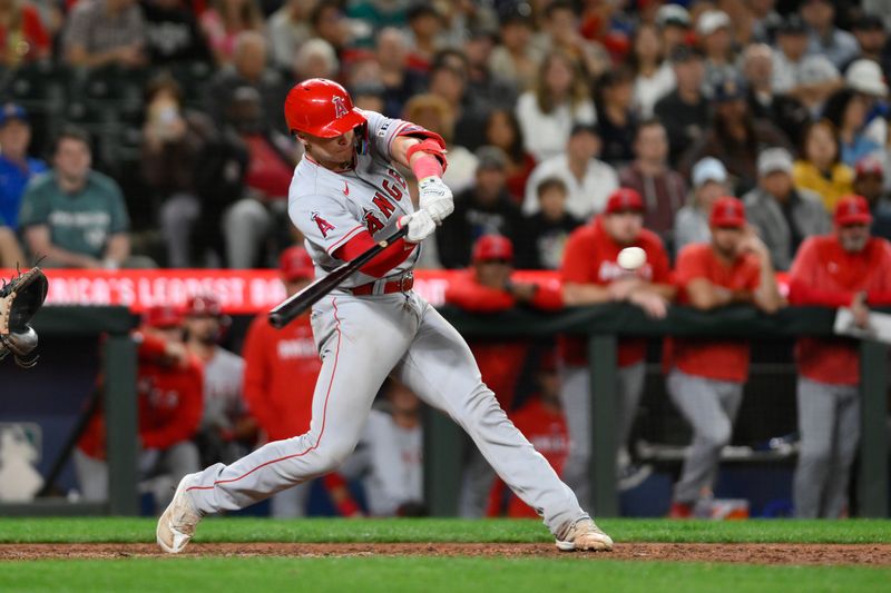 Sep 11, 2023; Seattle, Washington, USA; Los Angeles Angels catcher Logan O'Hoppe (14) hits a double against the Seattle Mariners during the ninth inning at T-Mobile Park. Mandatory Credit: Steven Bisig-USA TODAY Sports