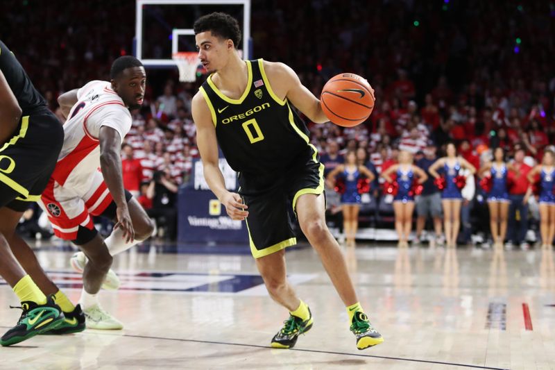 Feb 2, 2023; Tucson, Arizona, USA; Oregon Ducks guard Will Richardson (0) drives to the net against Arizona Wildcats guard Courtney Ramey (0) in the first half at McKale Center. Mandatory Credit: Zachary BonDurant-USA TODAY Sports