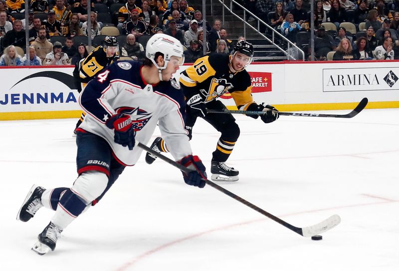 Mar 5, 2024; Pittsburgh, Pennsylvania, USA; Columbus Blue Jackets center Cole Sillinger (4) skates with the puck against the Pittsburgh Penguins during the third period at PPG Paints Arena.  The Penguins won 5-3. Mandatory Credit: Charles LeClaire-USA TODAY Sports