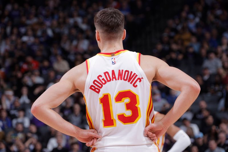 SACRAMENTO, CA - JANUARY 22: Bogdan Bogdanovic #13 of the Atlanta Hawks looks on during the game against the Sacramento Kings on January 22, 2024 at Golden 1 Center in Sacramento, California. NOTE TO USER: User expressly acknowledges and agrees that, by downloading and or using this Photograph, user is consenting to the terms and conditions of the Getty Images License Agreement. Mandatory Copyright Notice: Copyright 2024 NBAE (Photo by Rocky Widner/NBAE via Getty Images)