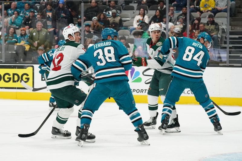 Apr 13, 2024; San Jose, California, USA; Minnesota Wild left wing Matt Boldy (12) scores a goal while defended by San Jose Sharks defenseman Mario Ferraro (38) during the first period at SAP Center at San Jose. Mandatory Credit: David Gonzales-USA TODAY Sports