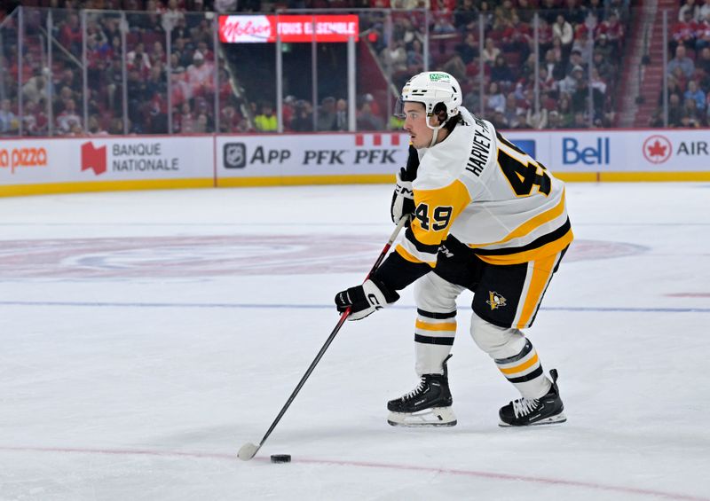 Sep 22, 2025; Montreal, Quebec, CAN; Pittsburgh Penguins forward Rafael Harvey-Pinard (49) plays the puck during the first period of the game against the Montreal Canadiens at the Bell Centre. Mandatory Credit: Eric Bolte-Imagn Images