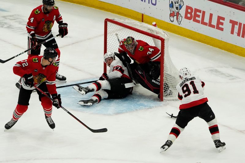 Feb 17, 2024; Chicago, Illinois, USA; Ottawa Senators right wing Vladimir Tarasenko (91) shoots the puck with center Shane Pinto (57) in the net as Chicago Blackhawks goalie Petr Mrazek (34) defends during the first period at United Center. Mandatory Credit: David Banks-USA TODAY Sports