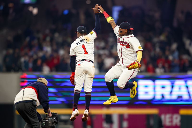 Apr 6, 2024; Atlanta, Georgia, USA; Atlanta Braves second baseman Ozzie Albies (1) and right fielder Ronald Acuna Jr. (13) celebrate after a victory against the Arizona Diamondbacks at Truist Park. Mandatory Credit: Brett Davis-USA TODAY Sports
