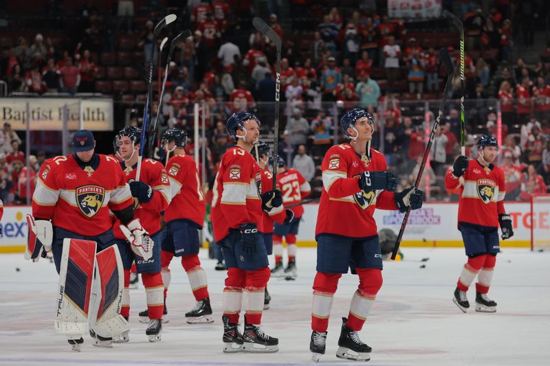 Nov 30, 2024; Sunrise, Florida, USA; Florida Panthers left wing Tomas Nosek (92) and center Sam Reinhart (13) celebrate after the gameagainst the Carolina Hurricanes at Amerant Bank Arena. Mandatory Credit: Sam Navarro-Imagn Images