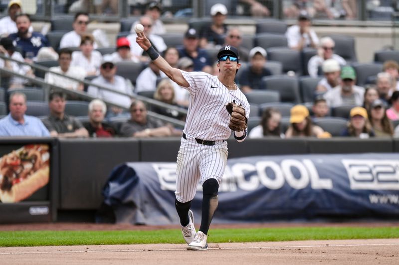 Aug 22, 2024; Bronx, New York, USA; New York Yankees third baseman Oswaldo Cabrera (95) fields a ground ball and throws to first base for an out against the Cleveland Guardians during the seventh inning at Yankee Stadium. Mandatory Credit: John Jones-USA TODAY Sports