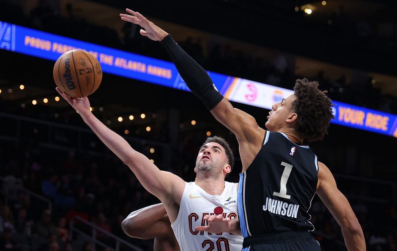 ATLANTA, GEORGIA - MARCH 06:  Georges Niang #20 of the Cleveland Cavaliers drives against Jalen Johnson #1 of the Atlanta Hawks during the first quarter at State Farm Arena on March 06, 2024 in Atlanta, Georgia.  NOTE TO USER: User expressly acknowledges and agrees that, by downloading and/or using this photograph, user is consenting to the terms and conditions of the Getty Images License Agreement.  (Photo by Kevin C. Cox/Getty Images)