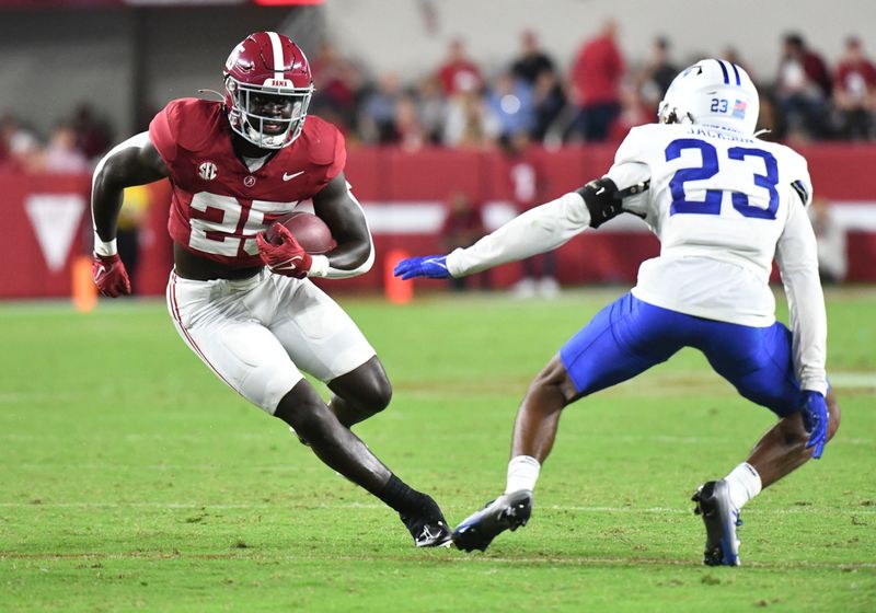 Sep 2, 2023; Tuscaloosa, Alabama, USA; Alabama Crimson Tide running back Richard Young (25)  runs the ball against Middle Tennessee Blue Raiders cornerback Jalen Jackson (23) during the second half at Bryant-Denny Stadium. Alabama won 56-7. Mandatory Credit: Gary Cosby Jr.-USA TODAY Sports