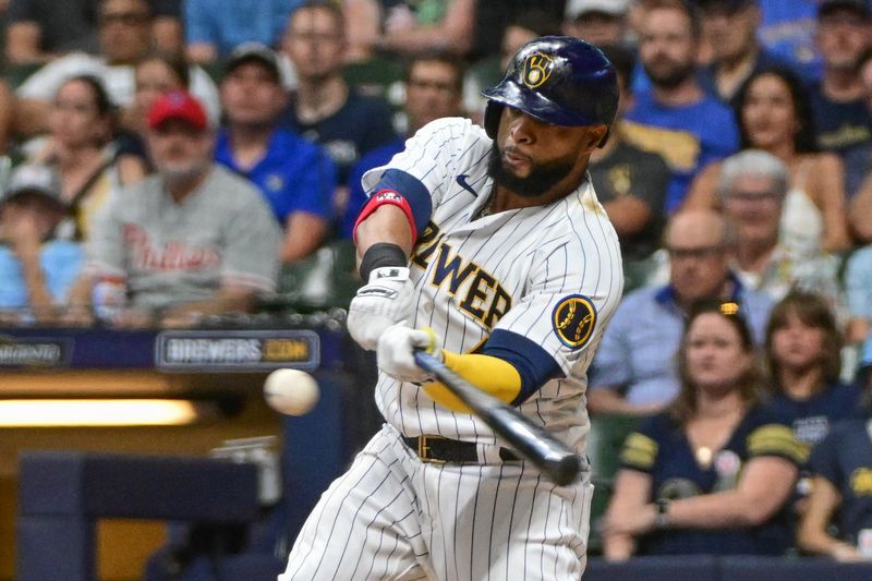 Sep 2, 2023; Milwaukee, Wisconsin, USA; Milwaukee Brewers first baseman Carlos Santana (41) hits a two run home run against the Philadelphia Phillies in the fifth inning at American Family Field. Mandatory Credit: Benny Sieu-USA TODAY Sports