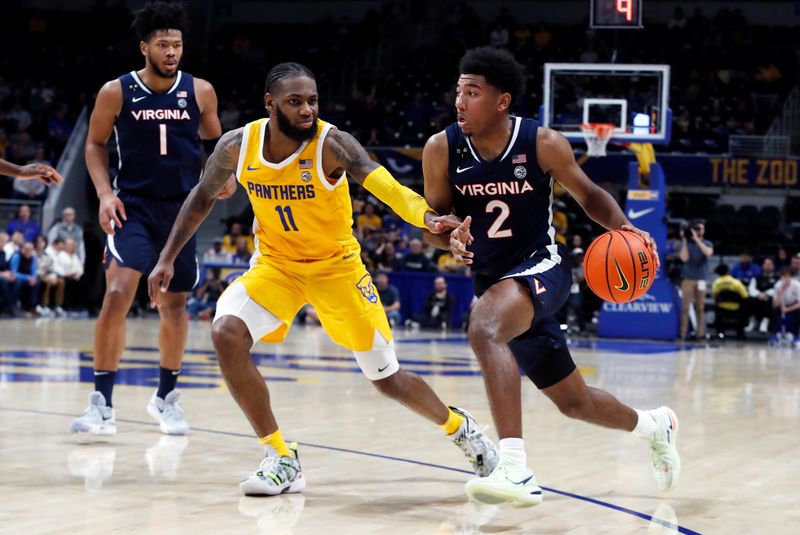 Jan 3, 2023; Pittsburgh, Pennsylvania, USA; Virginia Cavaliers guard Reece Beekman (2) drives to the basket  against Pittsburgh Panthers guard Jamarius Burton (11)  during the second half at the Petersen Events Center. Pittsburgh won 68-65. Mandatory Credit: Charles LeClaire-USA TODAY Sports