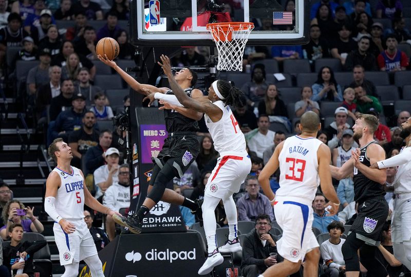 SACRAMENTO, CALIFORNIA - OCTOBER 22: Keegan Murray #13 of the Sacramento Kings goes up to shoot and is fouled by Terance Mann #14 of the LA Clippers during the first quarter of the game at Golden 1 Center on October 22, 2022 in Sacramento, California. NOTE TO USER: User expressly acknowledges and agrees that, by downloading and or using this photograph, User is consenting to the terms and conditions of the Getty Images License Agreement. (Photo by Thearon W. Henderson/Getty Images)