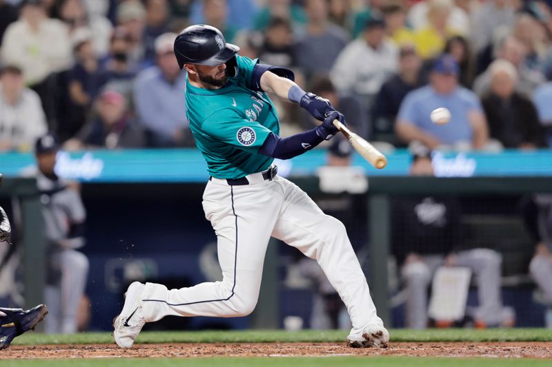 Jun 29, 2024; Seattle, Washington, USA; Seattle Mariners right fielder Mitch Haniger (17) hits a solo home run against the Minnesota Twins during the third inning at T-Mobile Park. Mandatory Credit: John Froschauer-USA TODAY Sports