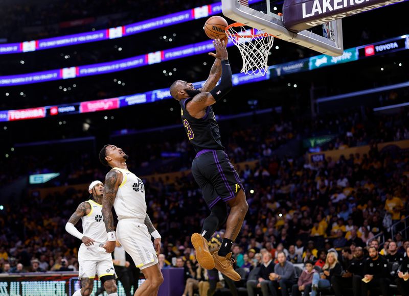 LOS ANGELES, CALIFORNIA - NOVEMBER 21: LeBron James #6 of the Los Angeles Lakers scores a basket on layup against John Collins #20 of the Utah Jazz during the first half of an In-Season Tournament game at Crypto.com Arena on November 21, 2023 in Los Angeles, California. NOTE TO USER: User expressly acknowledges and agrees that, by downloading and or using this photograph, User is consenting to the terms and conditions of the Getty Images License Agreement. (Photo by Kevork Djansezian/Getty Images)