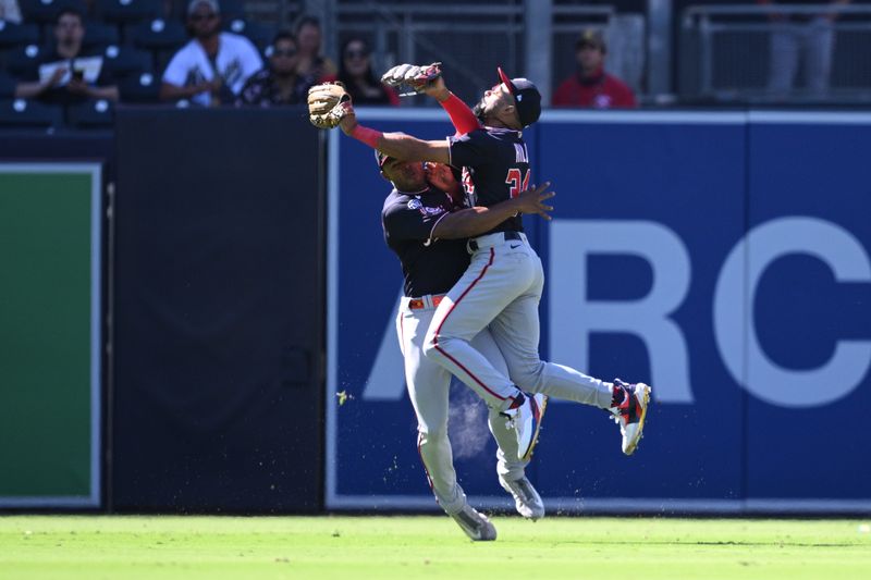 Jun 25, 2023; San Diego, California, USA; Washington Nationals center fielder Derek Hill (34) collides with left fielder Stone Garrett (36) after making a game-ending catch in the ninth inning against the San Diego Padres at Petco Park. Mandatory Credit: Orlando Ramirez-USA TODAY Sports