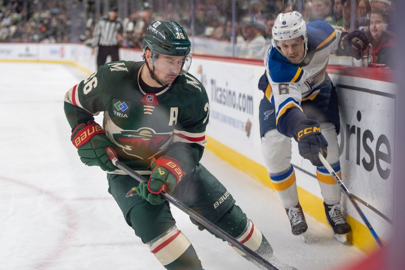 Jan 7, 2025; Saint Paul, Minnesota, USA; Minnesota Wild right wing Mats Zuccarello (36) plays the puck in the corner away from St. Louis Blues defenseman Philip Broberg (6) in the first period at Xcel Energy Center. Mandatory Credit: Matt Blewett-Imagn Images