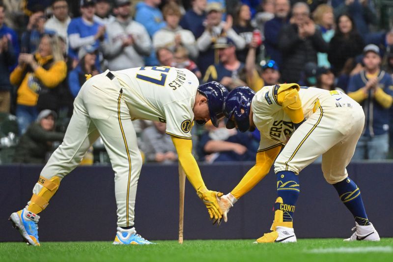 Apr 7, 2024; Milwaukee, Wisconsin, USA; Milwaukee Brewers catcher William Contreras (24) celebrates with shortstop Willy Adames (27) after hitting a two-run home run in the second inning against the Seattle Mariners at American Family Field. Mandatory Credit: Benny Sieu-USA TODAY Sports