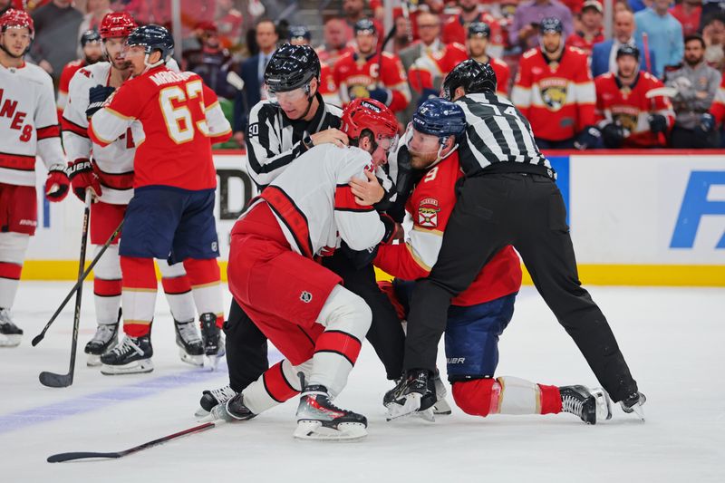 May 24, 2025; Sunrise, Florida, USA; Carolina Hurricanes right wing Andrei Svechnikov (37) and Florida Panthers center Sam Bennett (9) fight during the third period in game three of the Eastern Conference Final of the 2025 Stanley Cup Playoffs at Amerant Bank Arena. Mandatory Credit: Sam Navarro-Imagn Images