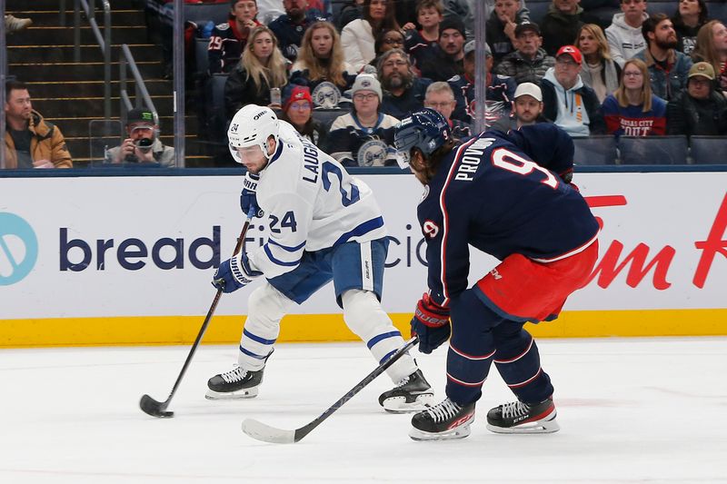 Nov 26, 2025; Columbus, Ohio, USA; Toronto Maple Leafs center Scott Laughton (24) carries the puck as Columbus Blue Jackets defenseman Ivan Provorov (9) defends during the first period at Nationwide Arena. Mandatory Credit: Russell LaBounty-Imagn Images