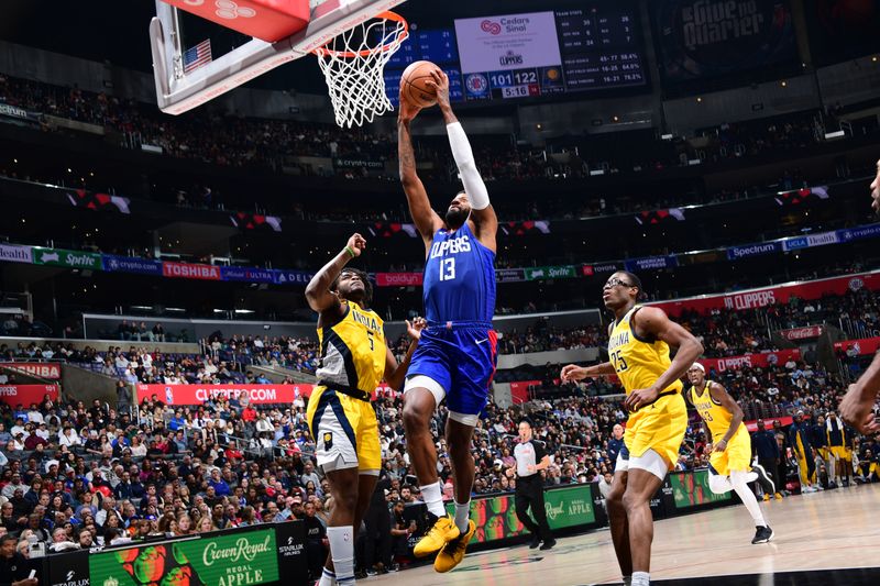 LOS ANGELES, CA - MARCH 25: Paul George #13 of the LA Clippers drives to the basket during the game against the Indiana Pacers on March 25, 2024 at Crypto.Com Arena in Los Angeles, California. NOTE TO USER: User expressly acknowledges and agrees that, by downloading and/or using this Photograph, user is consenting to the terms and conditions of the Getty Images License Agreement. Mandatory Copyright Notice: Copyright 2024 NBAE (Photo by Adam Pantozzi/NBAE via Getty Images)